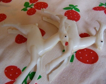 two wonderful white plastic deer