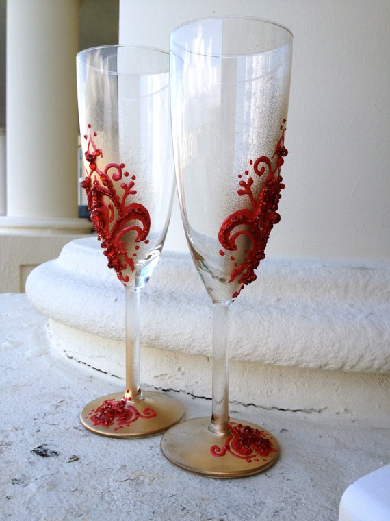 Hand decorated wedding champagne flutes in red and gold