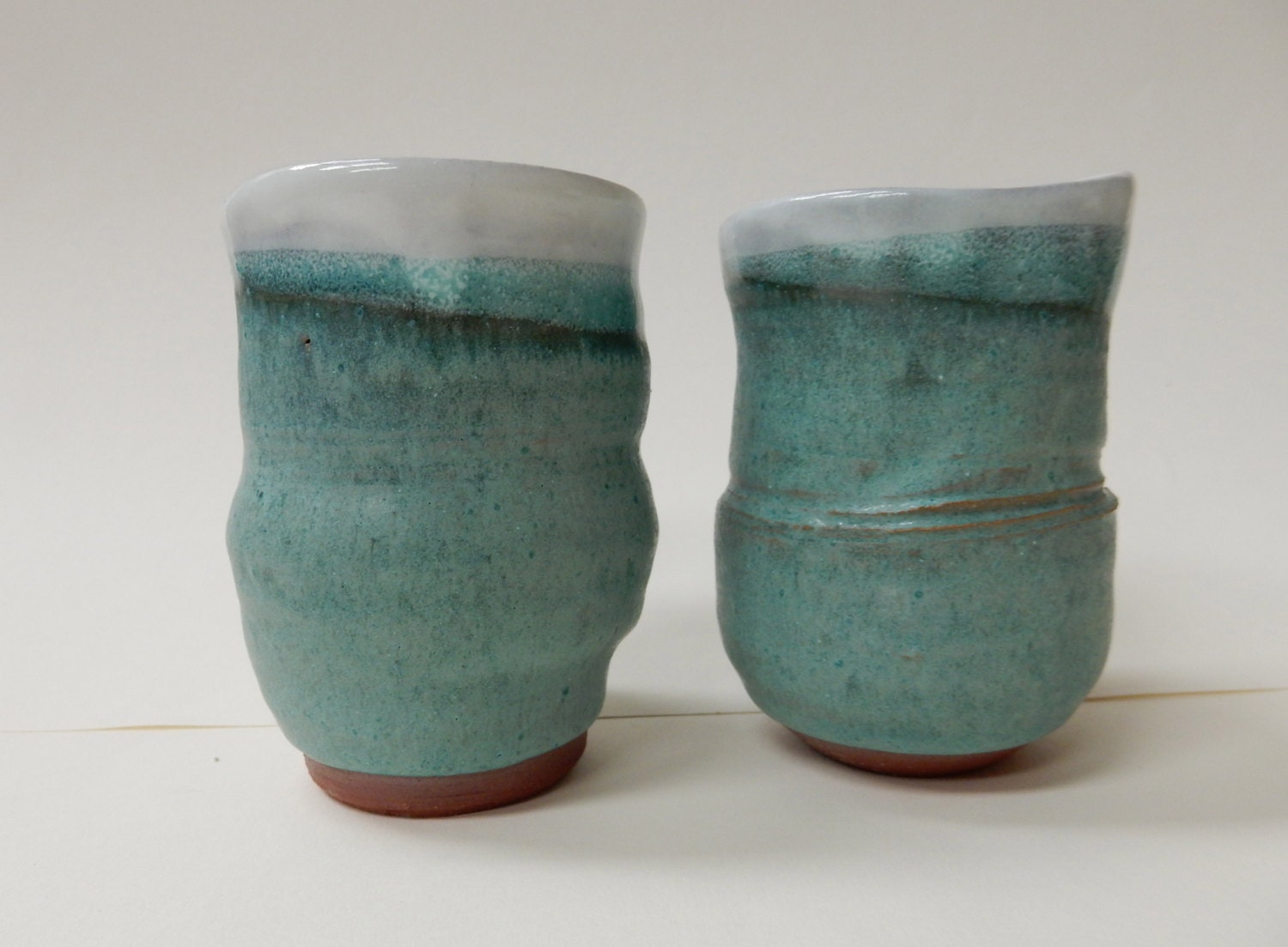 Two turquoise stoneware pottery wine cups or tea cup.
