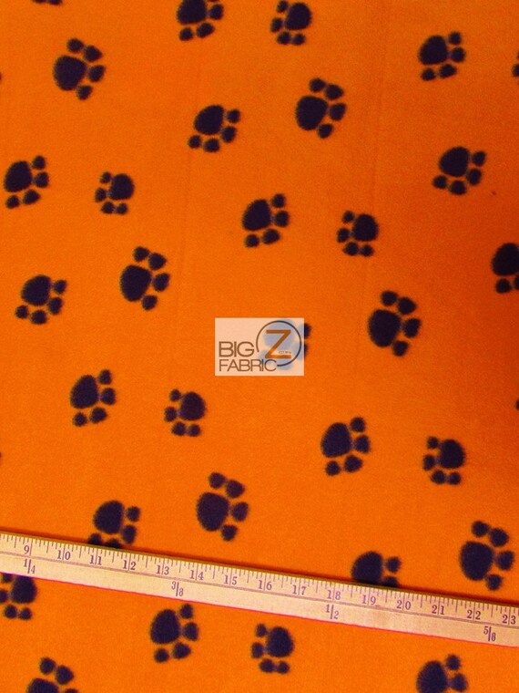 Paw Print Polar Fleece Fabric Orange/Black Paws Sold By