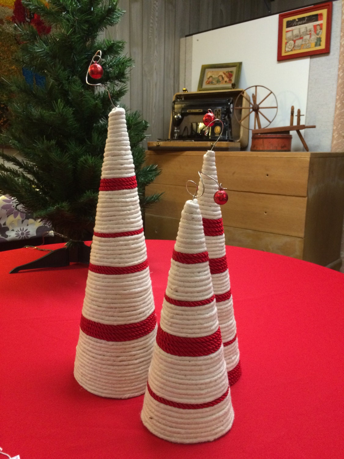 Cone Christmas trees wrapped in salvaged cord. White and red cord with fanciful topper. Set of 3