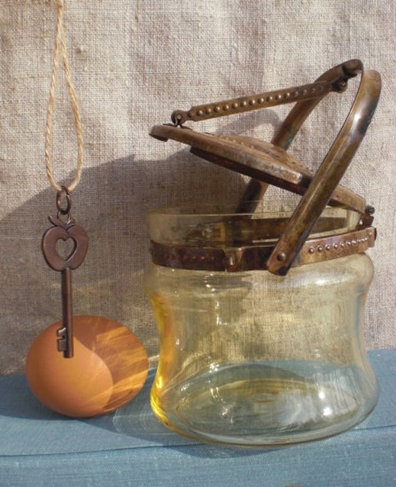 Yellow glass jar with mechanical metal lid by vintagefullhouse