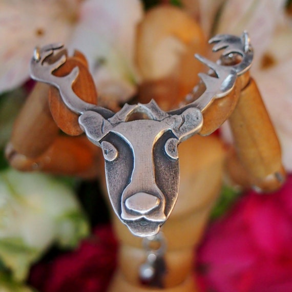 A unique stag reindeer necklace handmade in fine silver....