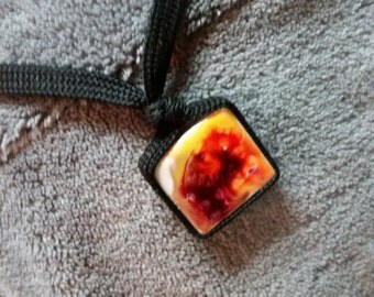 Choker with black string attached to small tile