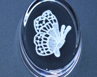 A machine hand finished lace butterfly in a new glass paper weight with gift box .