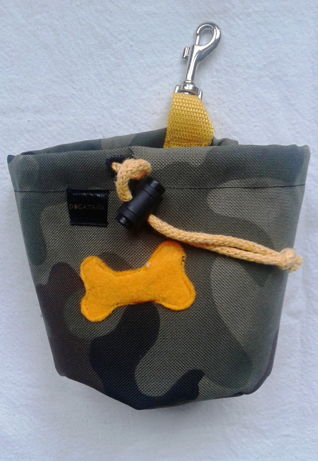 Camouflage dog treat bag with a bone