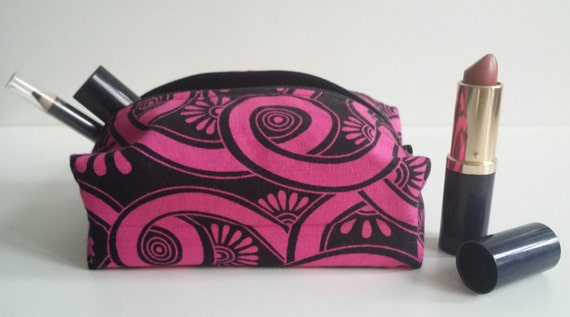 Psychadelic hot pink and black patterned make-up case with black zip and black lining. Compact but roomy with multiple uses.