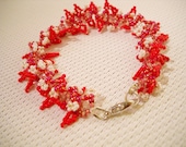 Beaded bracelet in shades of red decorated with smal leaves and flowers, handmade, chic, elegant, party, romantic, delicat,extra fine