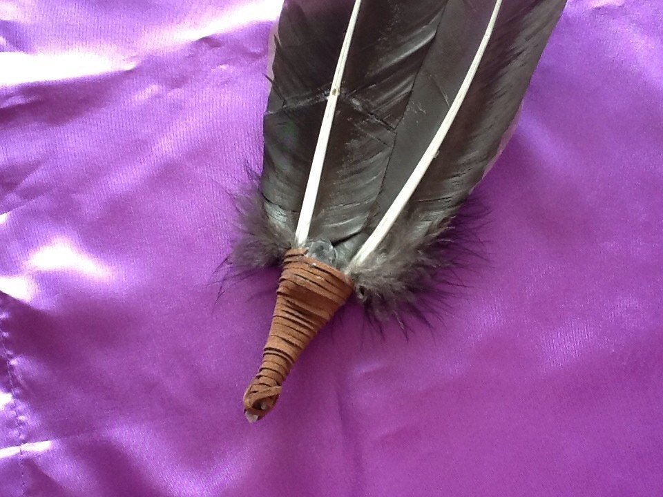 Turkey feather smudge wand with quartz crystal. 12 long