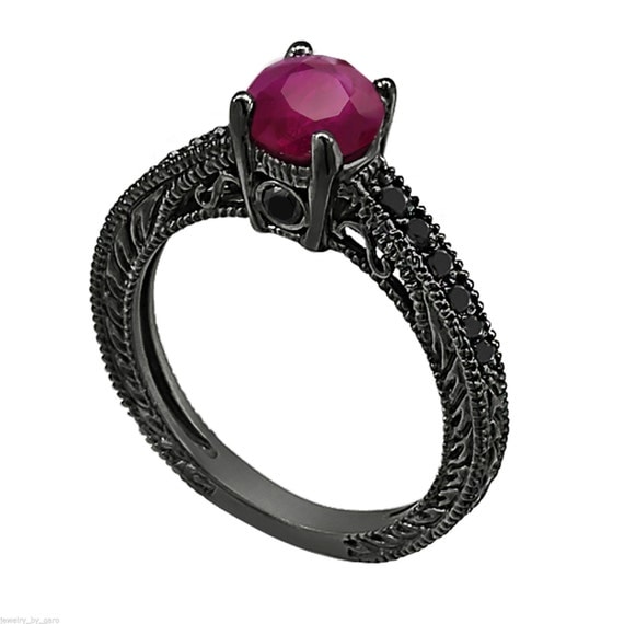 black ring with blue and pink gems