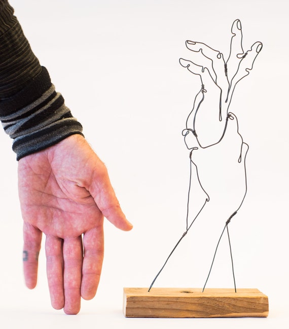 Steel wire sculpture hand grasping