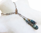 Paralian. Rustic lariat with graduated art bead pendants.