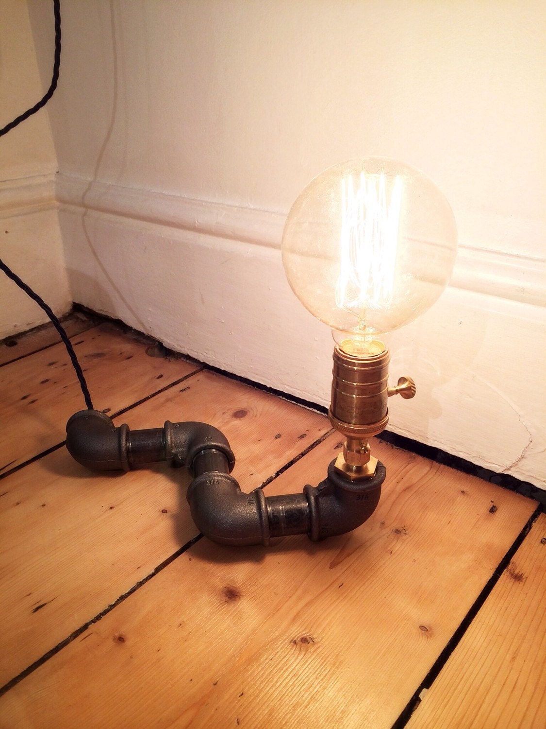 Black Steel Pipe Lamp with Brass Bulb Socket completed with