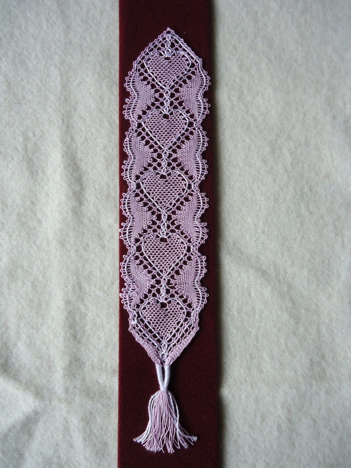 Handmade bobbin lace bookmark in white with a repeated heart