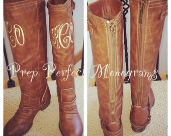 monogram plaque long leather boots