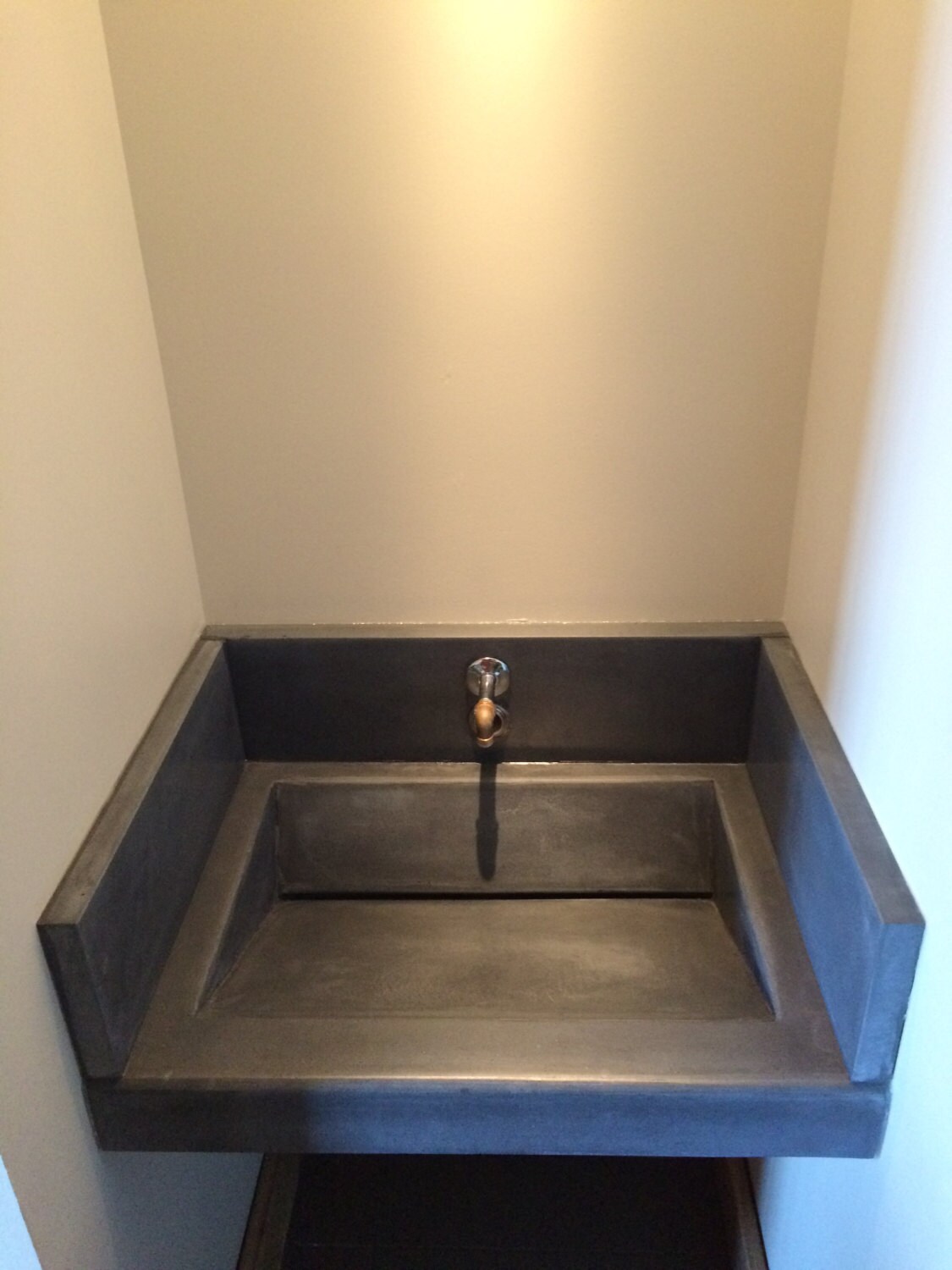 Precast concrete vanity slant sink.