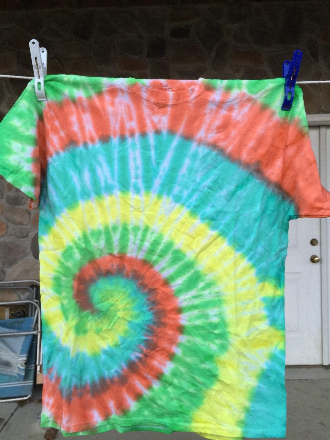 Green yellow blue and orange tie dye shirt. by AllTieDyeEverything