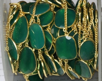 green setting with gold plated chain.