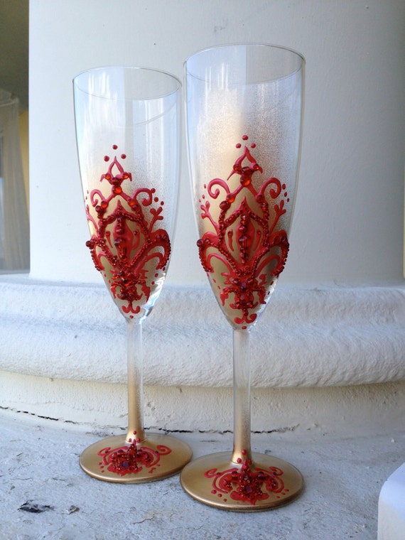 Hand decorated wedding champagne flutes in red and gold