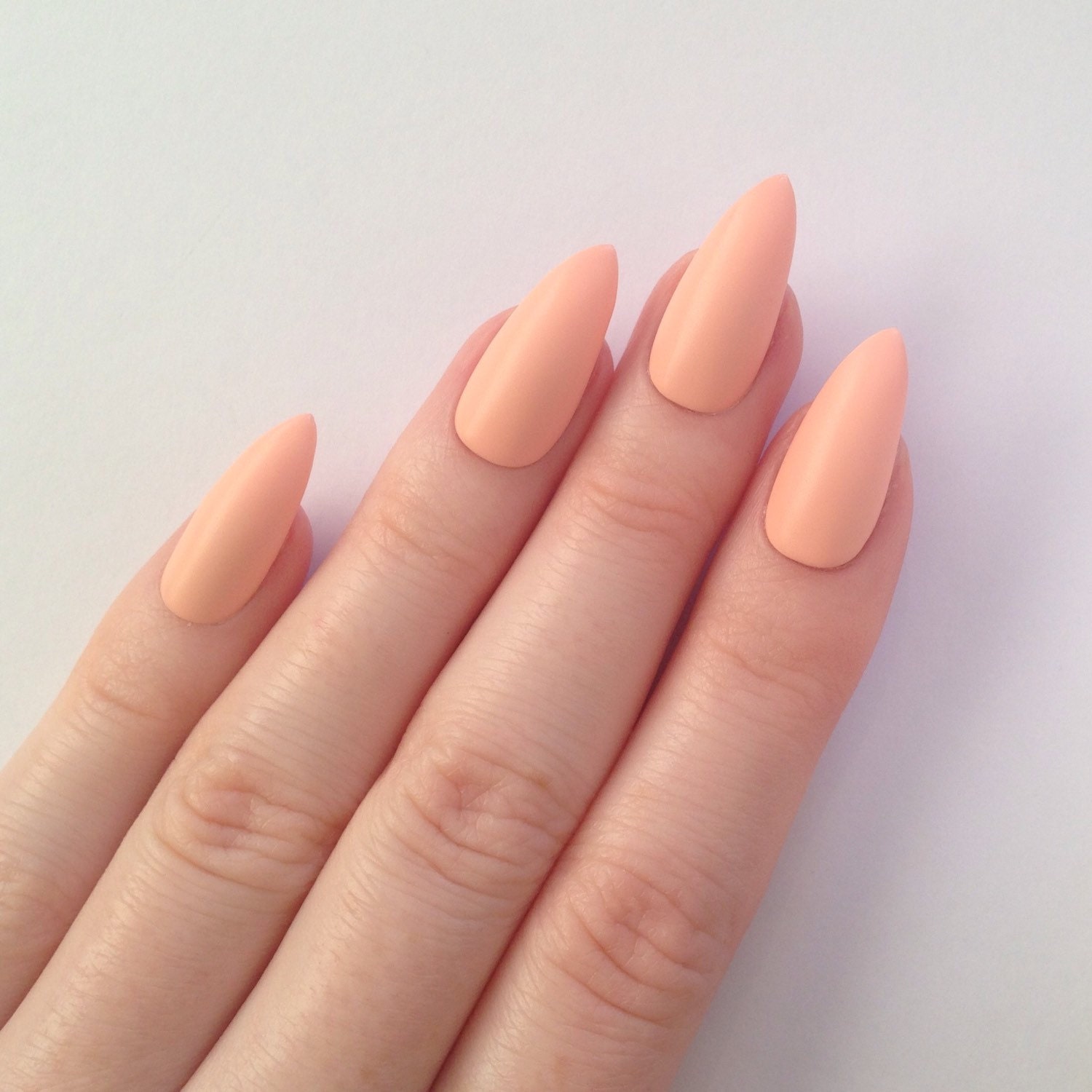 Matte pastel peach stiletto nails Nail by prettylittlepolish