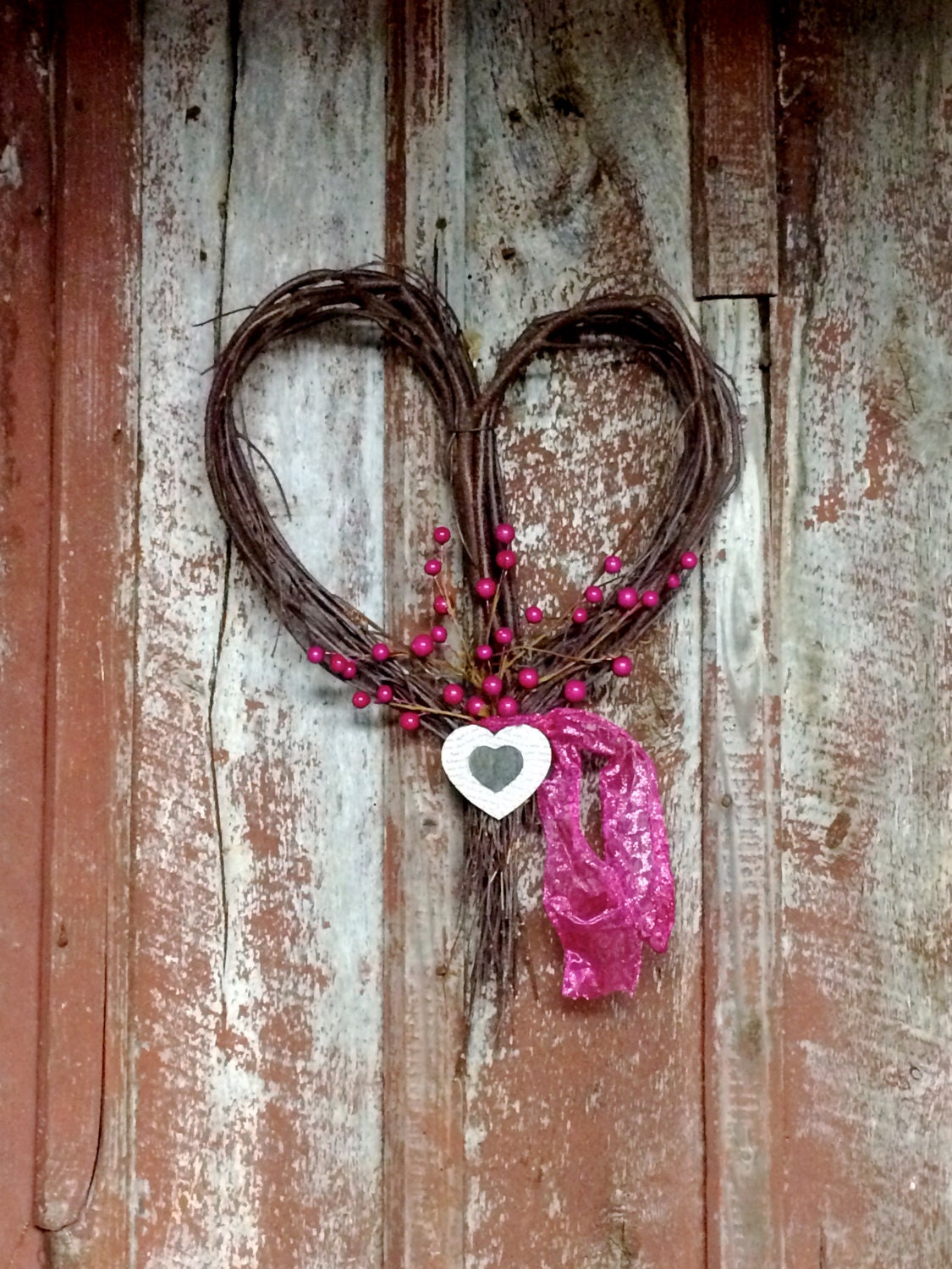 Heart-shaped Rustic Twig wreath with dark Pink berries wooden