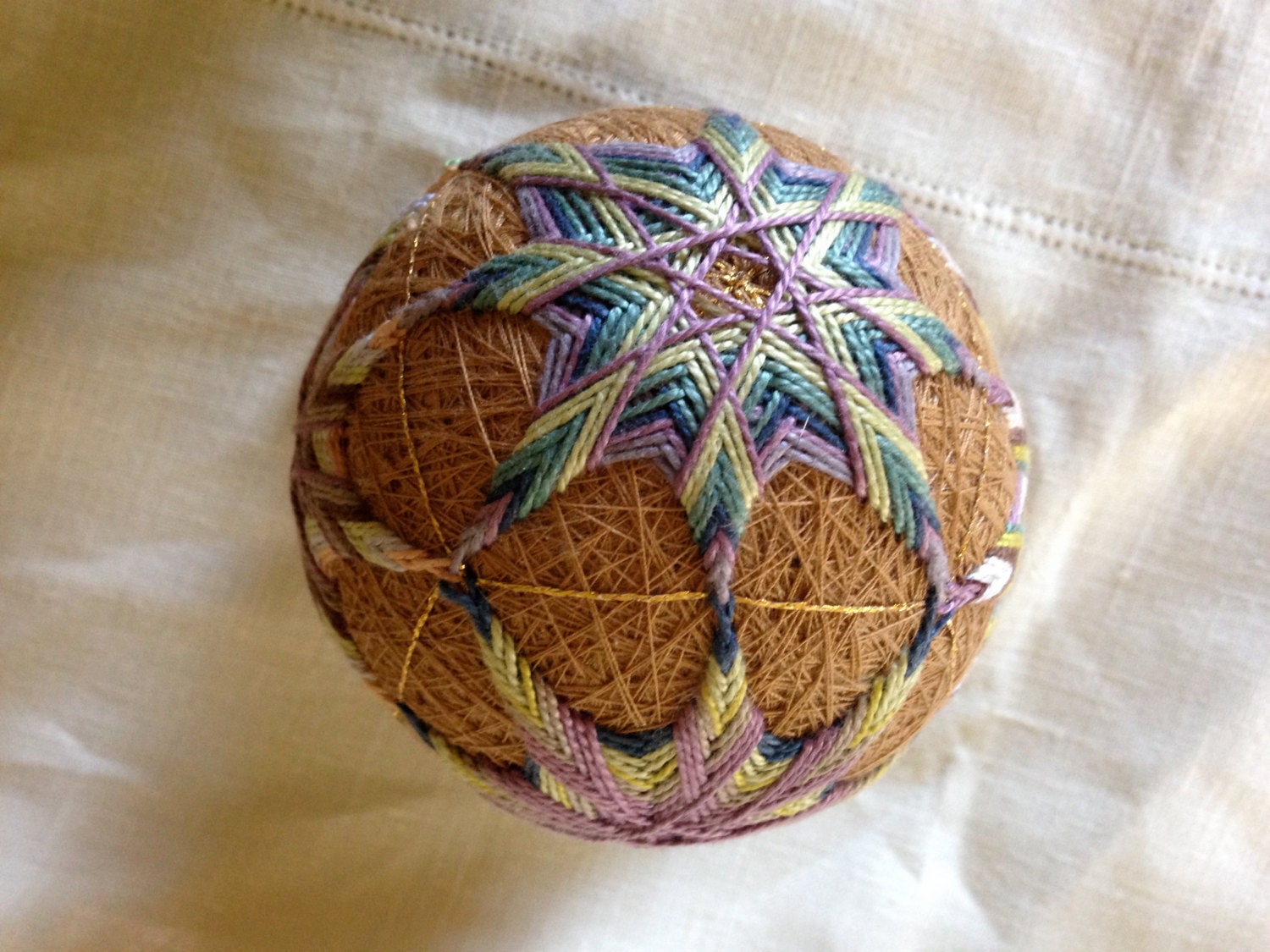 This hand crafted temari ball is worked in a patchwork pattern