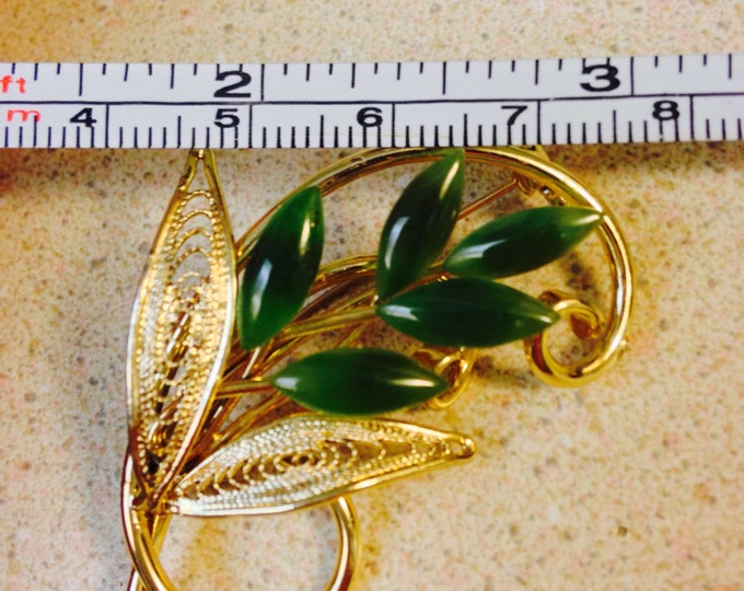 Storewide 25% Off SALE Beautiful vintage 2" goldtone and jade brooch featuring a swirling stem and openwork leaf design with marquis jade st