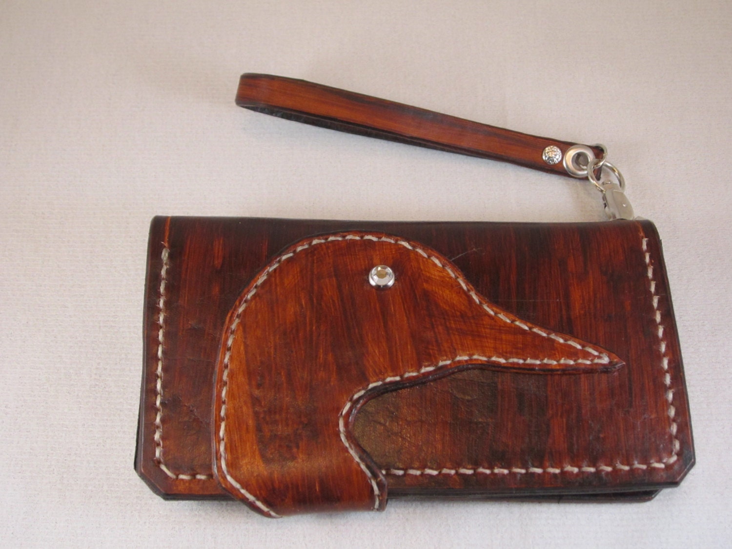 Lady's leather handcrafted wallet with wrist strap.