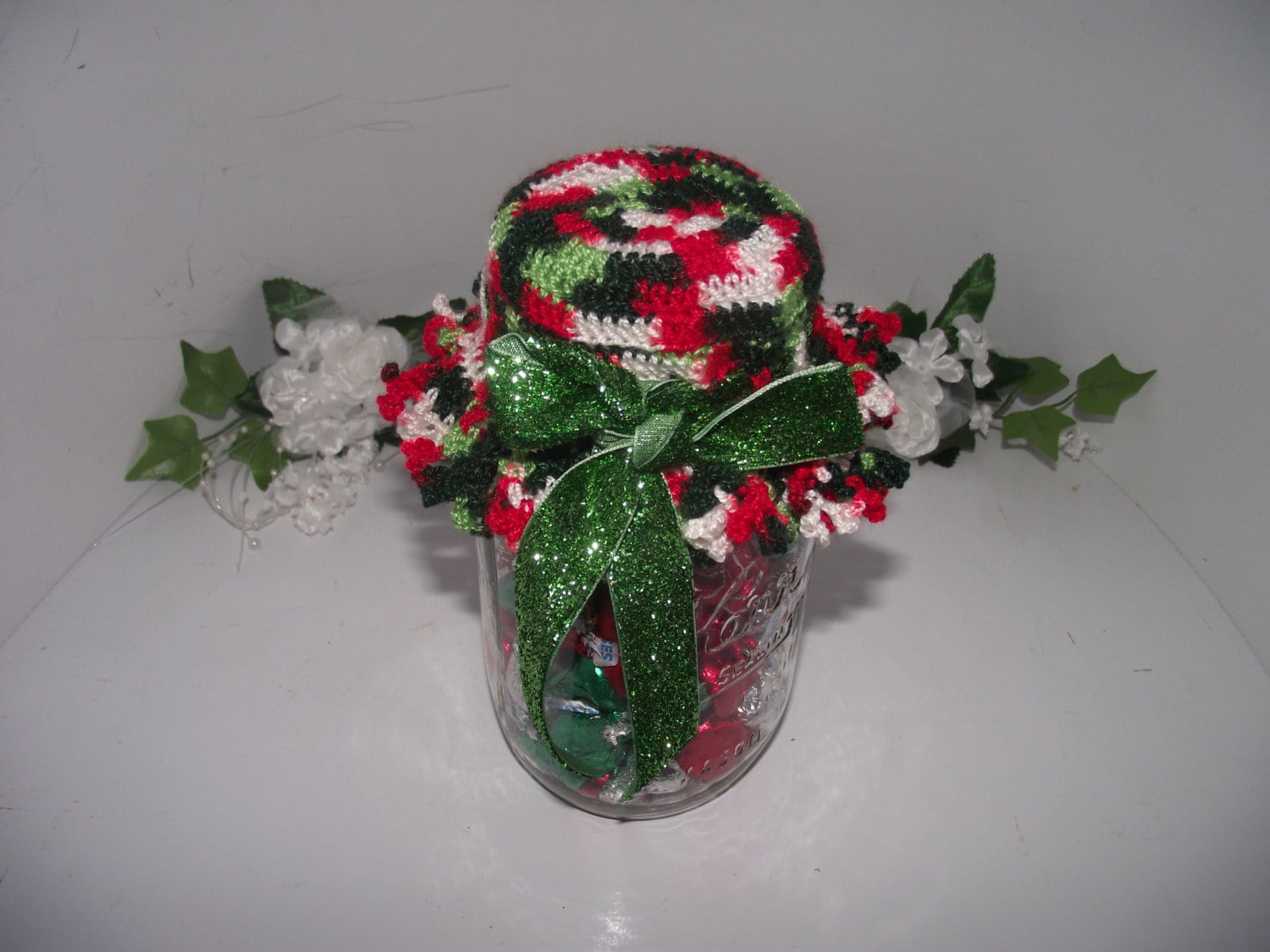 Crochet Christmas jar lid covers with a sparkle ribbon