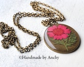 Real pressed pink flower blossom in crystal clear resin antique bronze colored pendant base with necklace