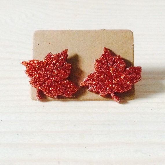 Items similar to orange glitter leaf earrings on Etsy
