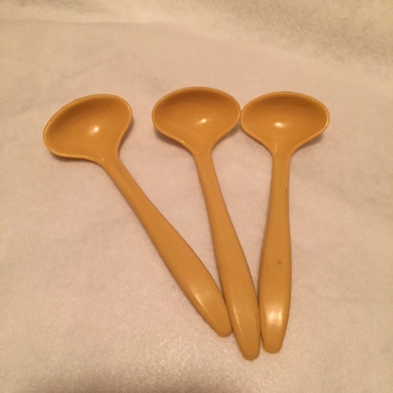 3 yellow Tupperware condiment spoons