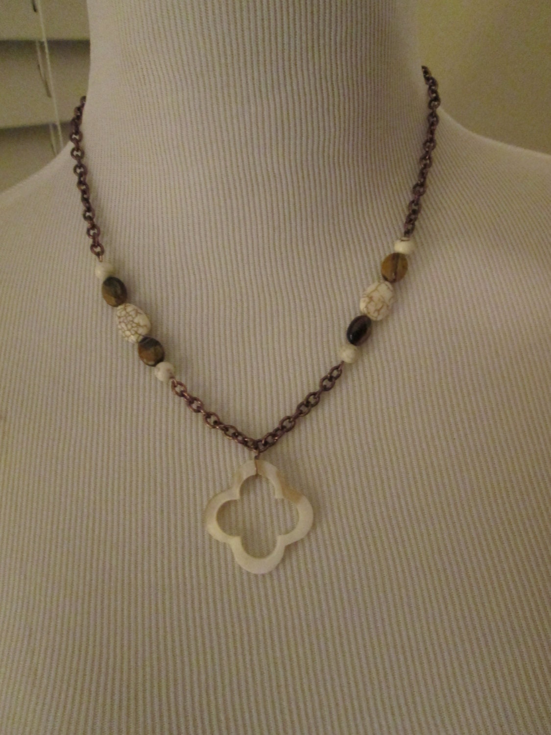 Bronze chain necklace with cream colored accent beads and
