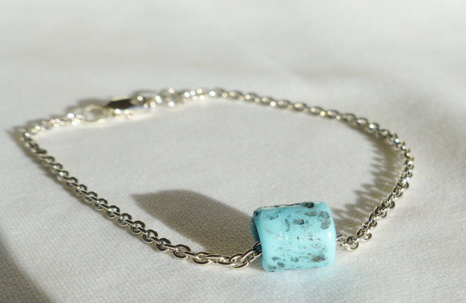 silver chain with blue stone