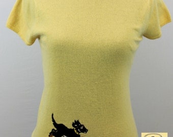 Lemon yellow cashmere sweater with cap sleeves embroidered with running puppy design.