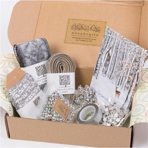 A curated + themed holiday craft box of unique and high quality craft supplies - silver ribbon, trim, beads, pendant, stars