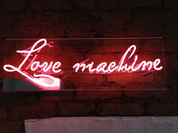 Neon lights sign on acrylic box. LOVE MACHINE