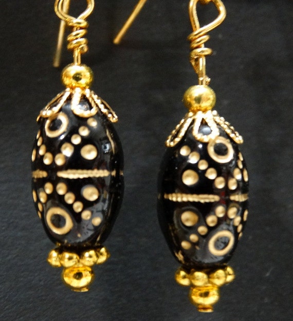 Gold designs on black bead earrings