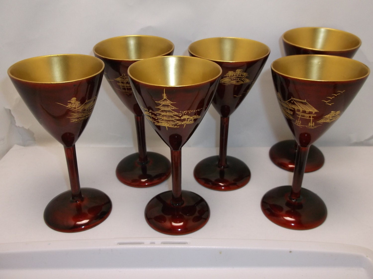 A rare set of six Japanese negoro red with good makie E lacquer stem