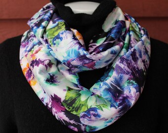 Bold Infinity scarf in a multi-colored floral print in vibrant colors of blue, purple, yellow and green