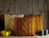 Mustard yellow cable knit pillow cover with 3 wooden buttons.