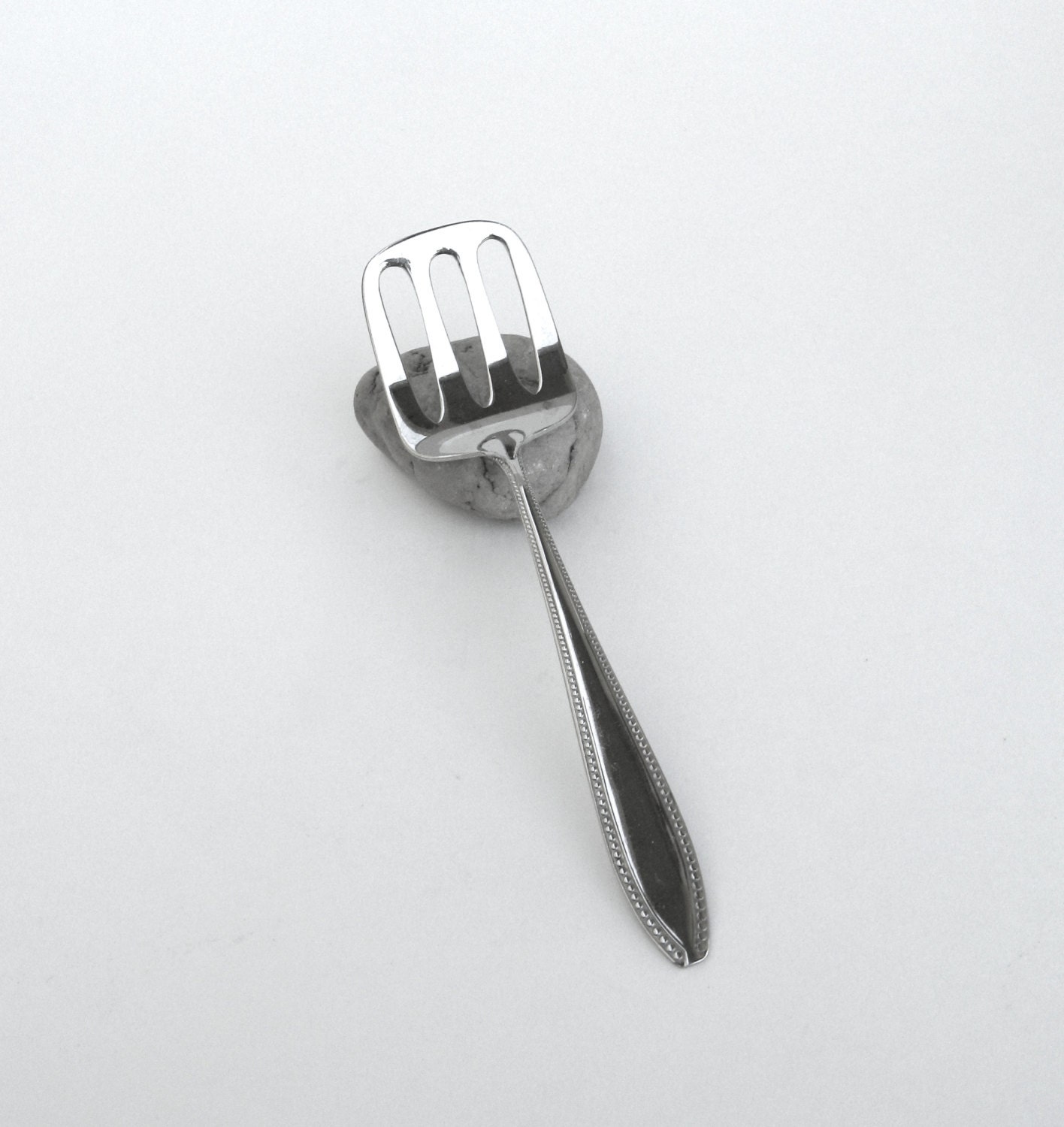 vintage silver spoon … slotted shovel … mid century modern Haute Juice