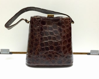 ... , dark brown with caramel colored leather interior, and snap closure