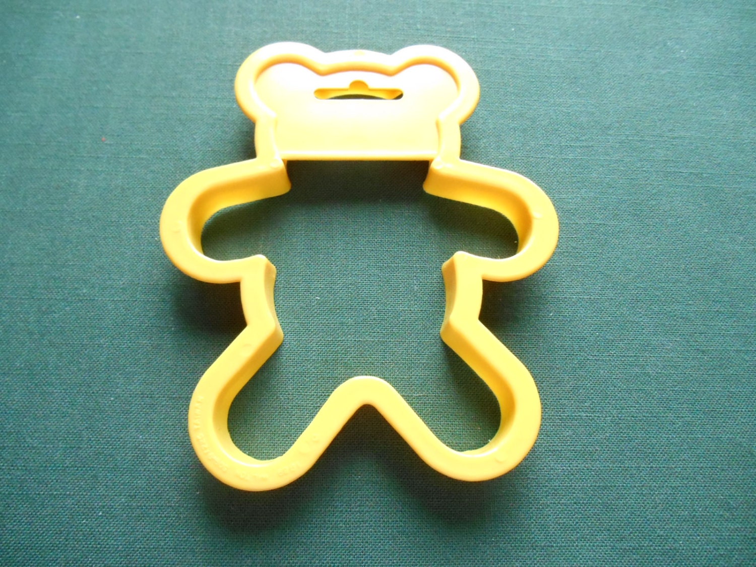 A Wilton Yellow Teddy Bear Shaper Cookie Cutter 4 5/8 inch