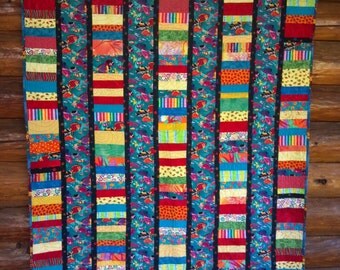 Child's quilt. Bright, scrappy fish quilt. 59 x 71 inches.Somethin's Fishy Around Here.