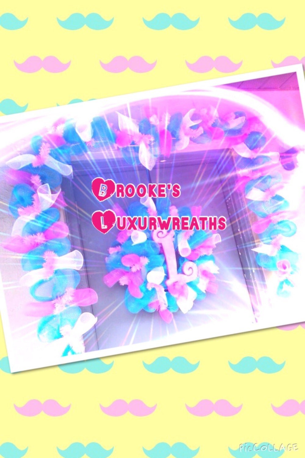 Whimsical blue, pink, and white deco mesh wreath. Combination of pouf and curl in the mesh, tied with pink ties, and a glittery letter.