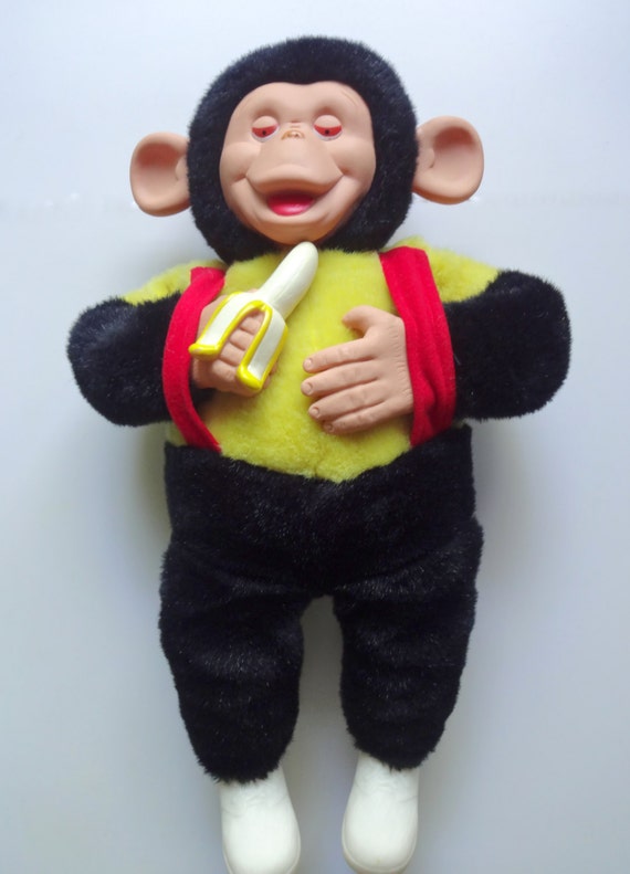 stuffed yellow and black monkey with banana