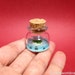 Heart island, there are many fish and a turtle around it in a tiny bottle light blue ver.1