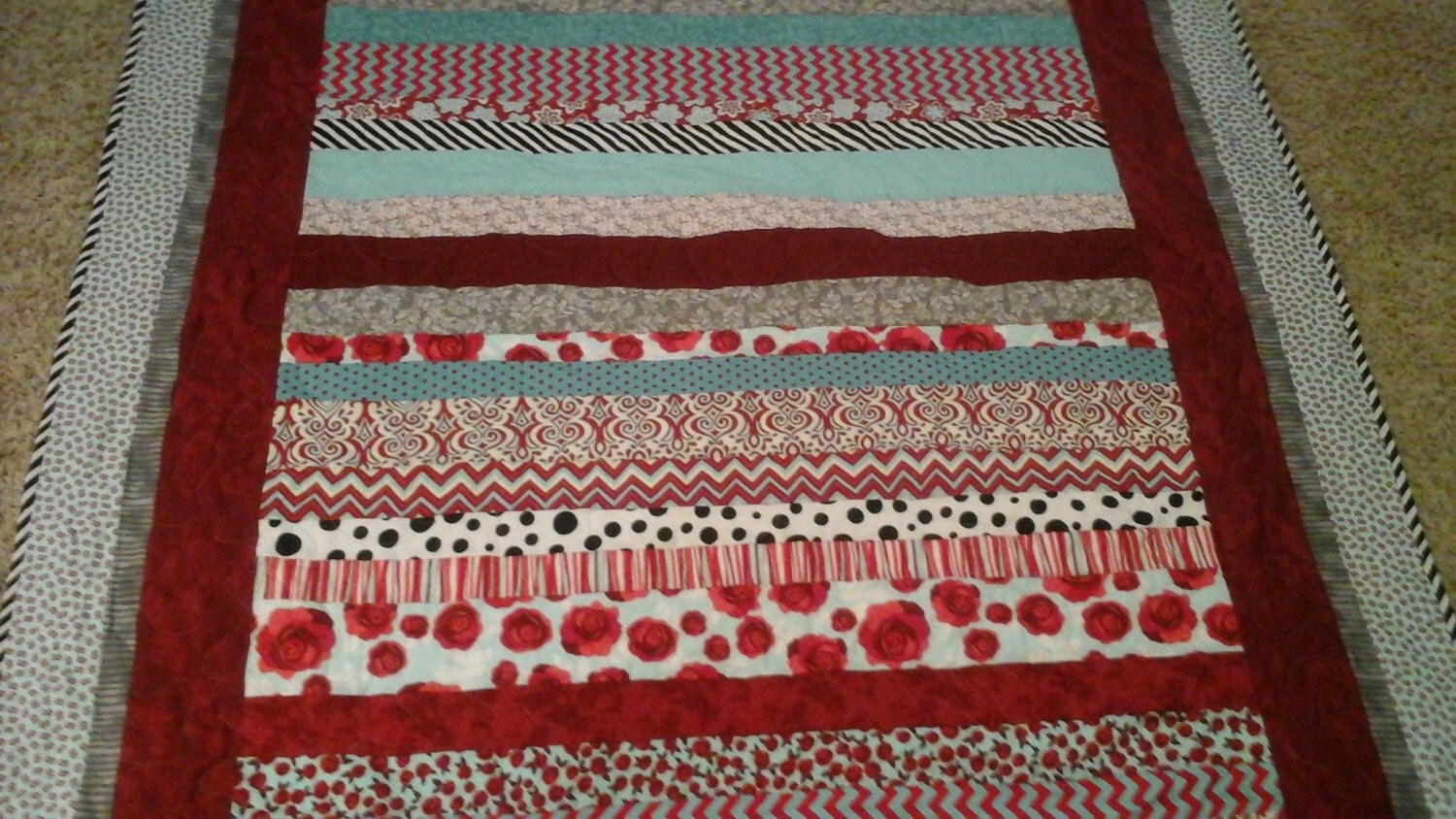 twin size red and turquoise quilt