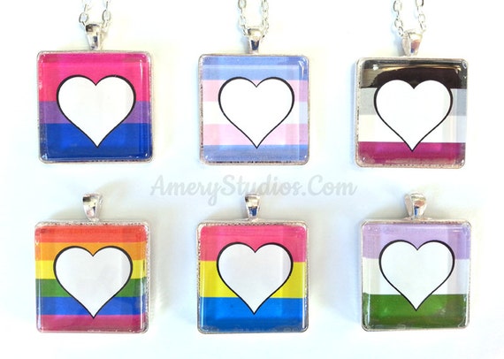 Photo of 6 square necklaces, each showing the colors of a different LGBTQ pride flag, with a heart in the middle of the design.